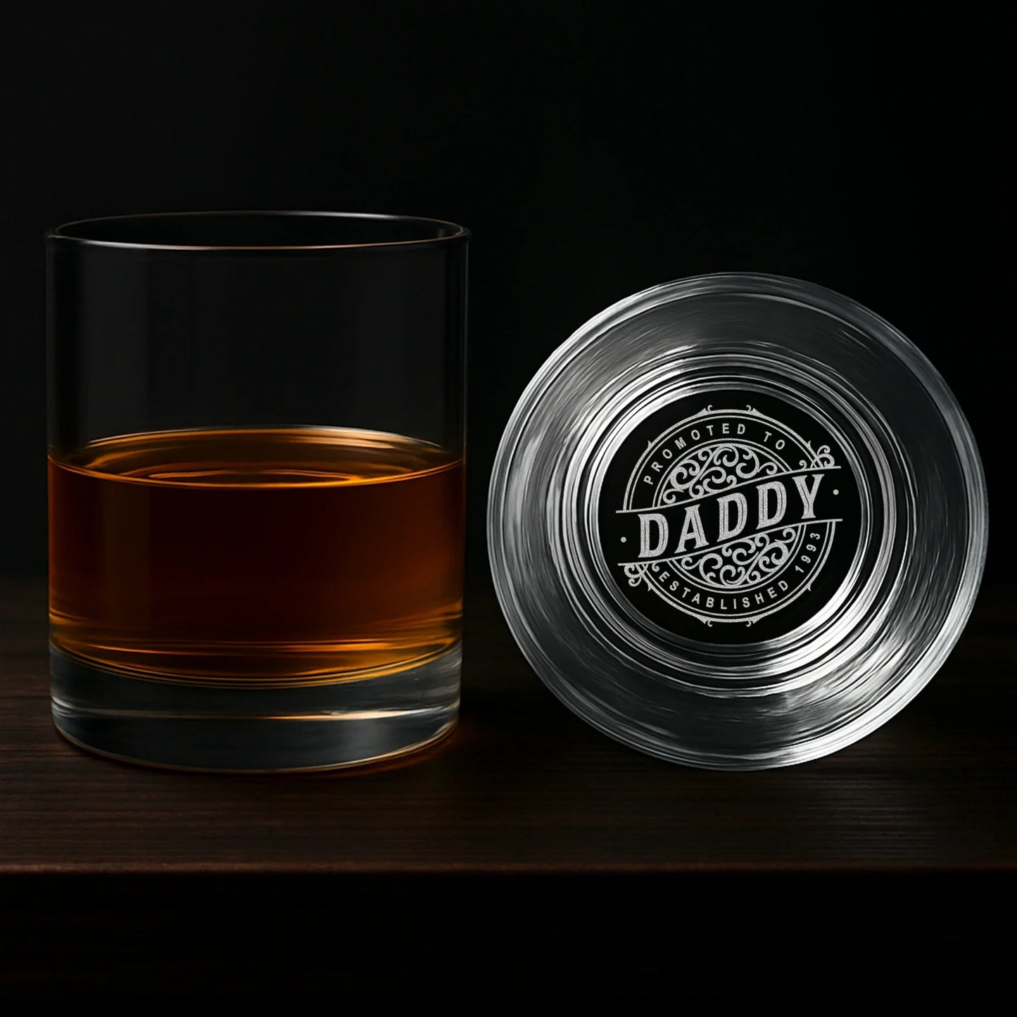 Personalized whiskey glass with engraved 'Daddy' design on base, filled with bourbon