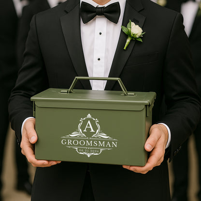 Groomsman in tuxedo holding personalized green gift box with white floral boutonniere