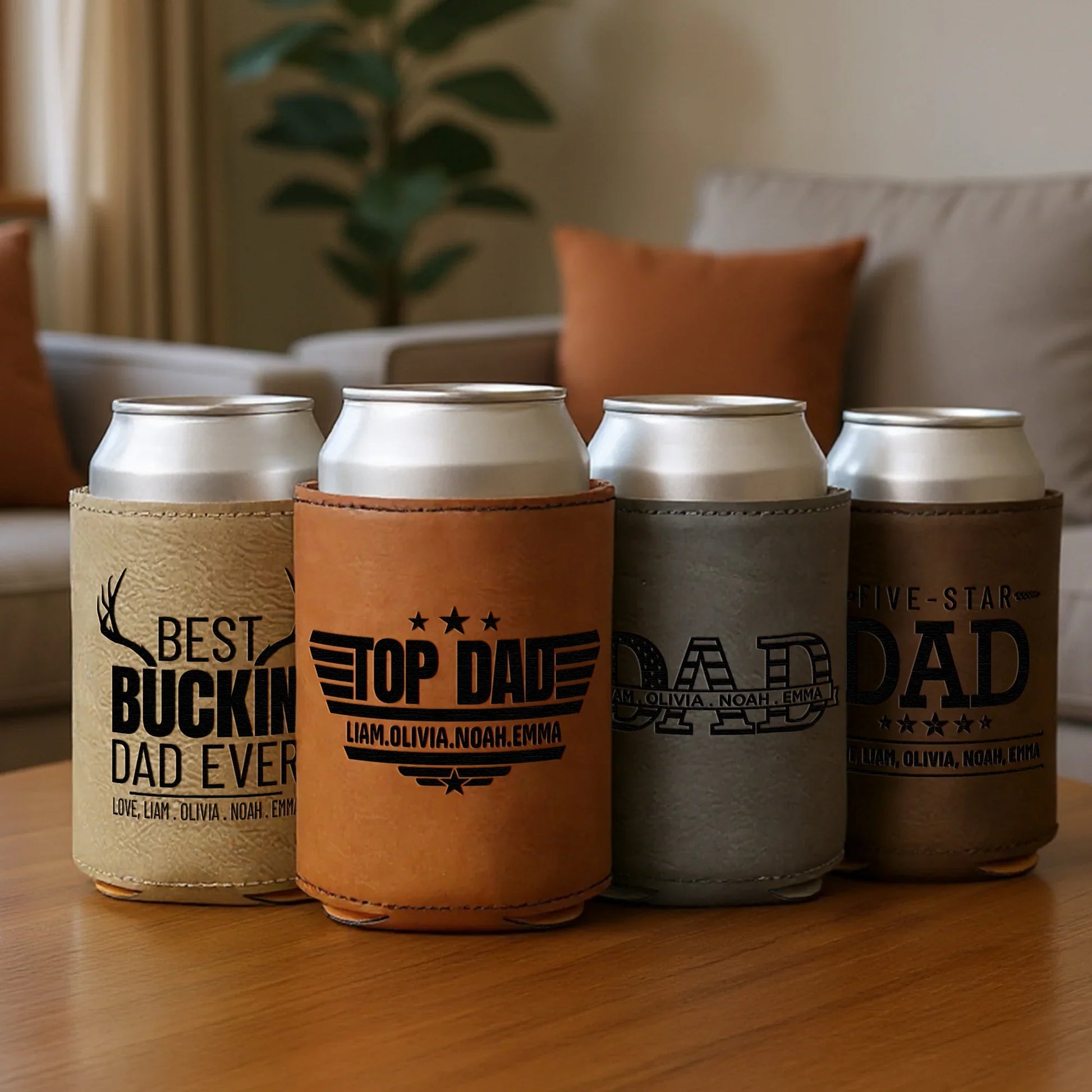 Personalized leather can coolers for dad with engraved messages on a coffee table in a cozy living room.
